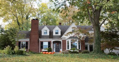 Red Brick House in Wooded Setting with Pumpkins clipart