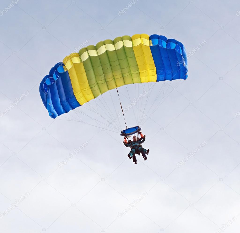 Tandem Skydivers with colorful parachute.