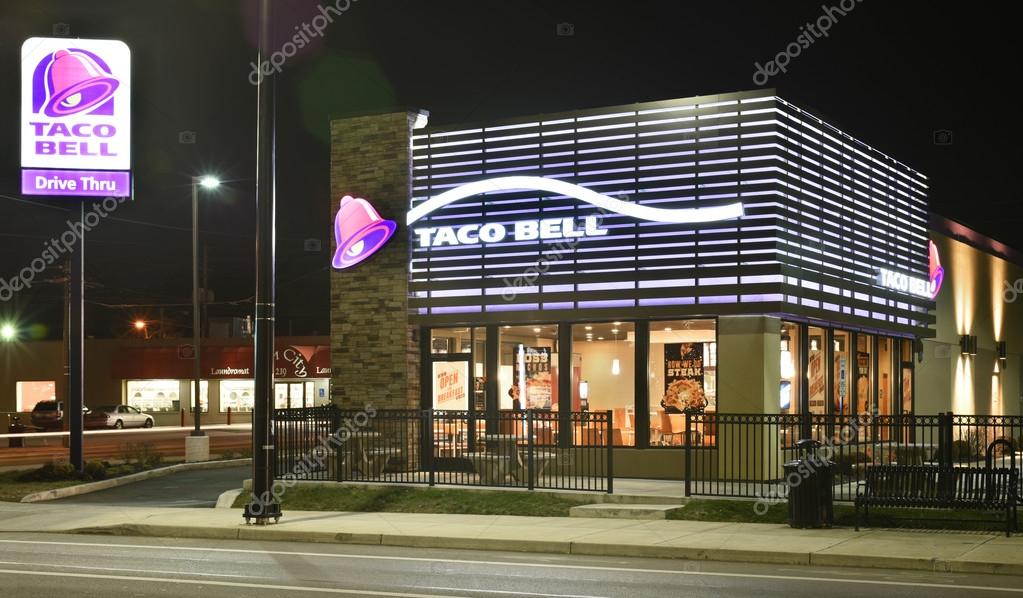 DAYTON, OHIO, USA - DECEMBER 13, 2015: Taco Bell Restaurant, shown here at night in its newer 2013 purple design, has recently announced its implementation of exclusively using cage-free eggs in its 6000 US locations by the end of 2016.