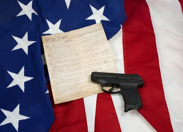 Constitution with Hand Gun on American Flag. Horizontal — Stock Photo, Image