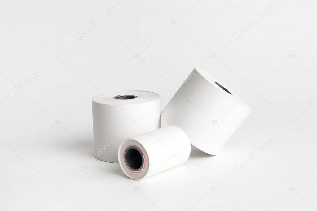 Rolls of white paper on a white background stacked on top of each other