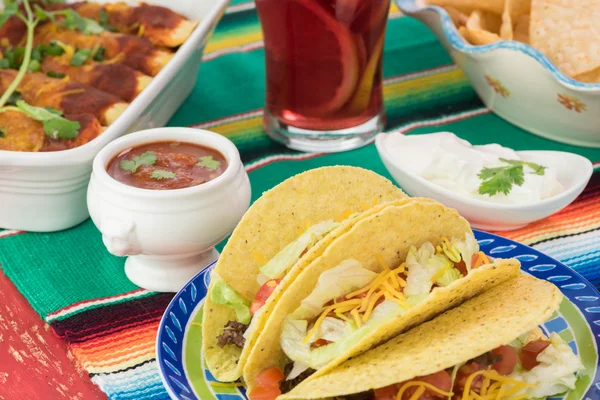 Mexican fiesta table.Tacos, enchiladas, plate with chips, salsa. — Stock Photo, Image