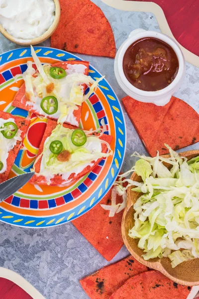 Cut, fried, red quesadillas,  with lettuce, salsa and sour cream — Stock Photo, Image