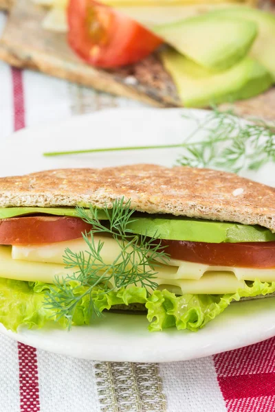Pita pocket sandwich with cheese, avocado, tomato and lettuce. — Stock Photo, Image