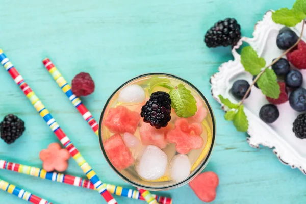 Ingredients and glass of berries and fruit, mint infused water. — Stock Photo, Image