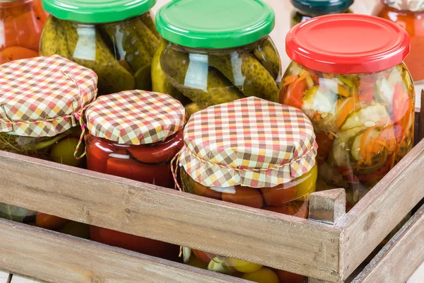 Assorted vegetable pickles in glass jars and roasted red pepper — Stock Photo, Image
