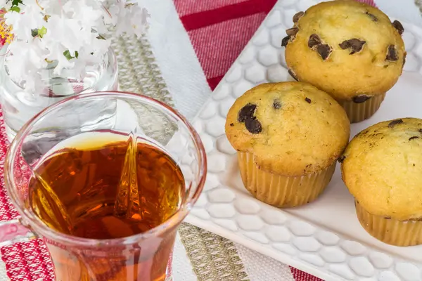 Mini choklad chips muffins och kopp te. — Stockfoto