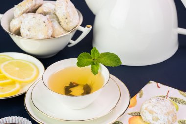 Çay bardağı ile yeşil çay ve kurabiye.