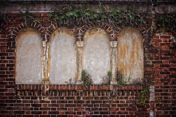 old brick wall with a large window