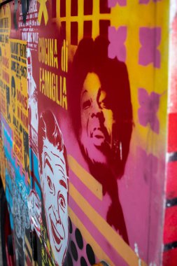 colorful poster on the wall in a street