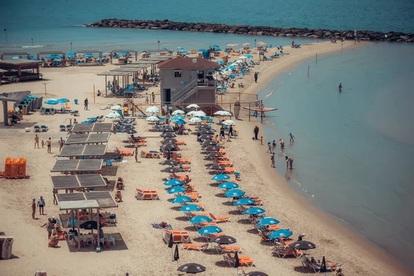 aerial view of the beach with people at the sea