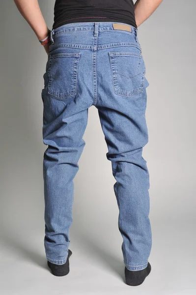 Youth jeans put on the guy — Stock Photo, Image