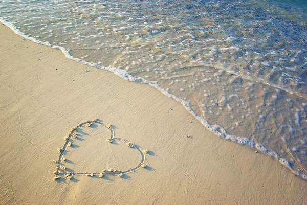 Heart drawn in the sand. Stock Picture