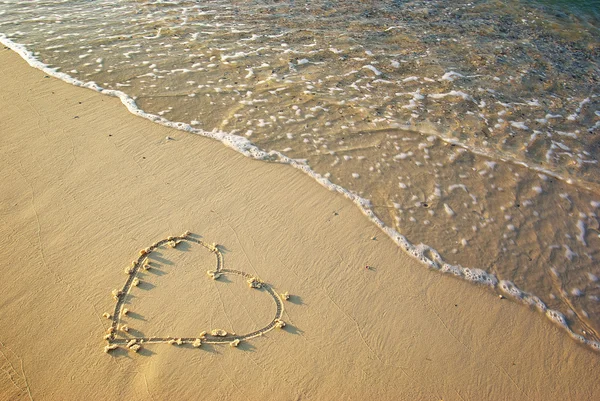 Heart drawn in the sand. Stock Photo