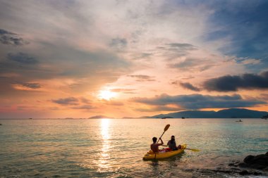 Couple kayaking in sunset, holiday vacation summer times, dating, romantic, romantic, vintage tone clipart