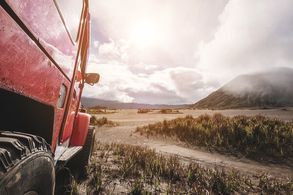 Red off road car at Mount Bromo, Indonesia, adventure trial