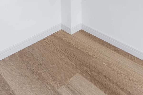 Wood Floor White Wall Stock Image