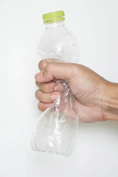Male hand squeeze plastic bottle — Stock Photo, Image