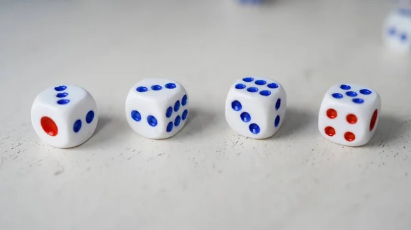 Randomly arranged white dice with blurry dice background