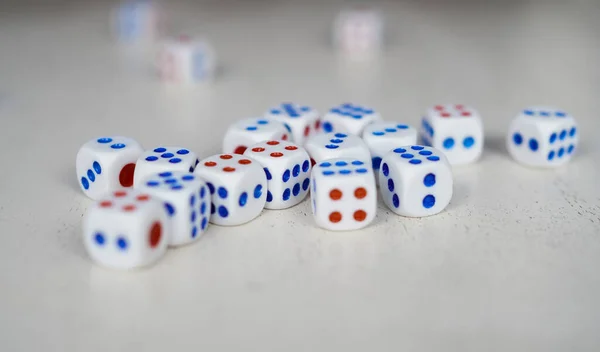 Randomly arranged white dice with blurry dice background