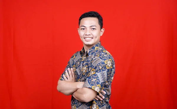 Asian Man Stylish Batik Clothes Studio Isolated Red Background — Stock Photo, Image