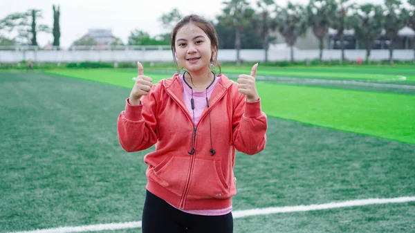 Asian Runner Woman Wearing Jacket Earphone Gesture — Stock Photo, Image