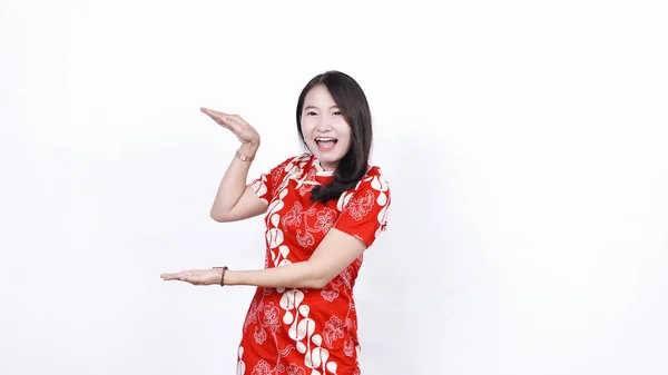 中国の伝統的なドレスを着ているアジアの女性左空白のスペースを指す隔離された白い背景 — ストック写真