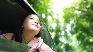 Arabayla seyahat eden mutlu Asyalı kadın portresi. 