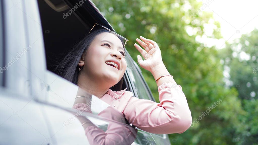 portrait of happy asian woman travelling with a car 