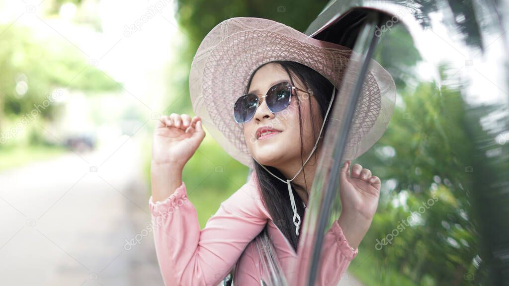 portrait of happy asian woman travelling with a car 