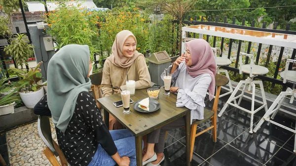 Asian group hijab woman smilling in cafe with friend