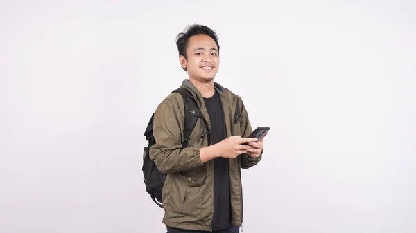 Young Man Wearing Isolated Bag White Background Holding Phone — Stock Photo, Image