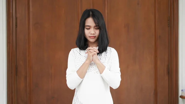 a Christian woman praying humbly in church