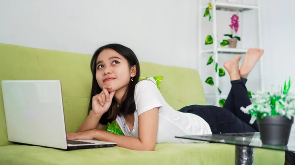 asian women sitting on chair work from home at laptop and thinking of problem solution