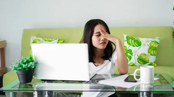Stressed Asia woman work from home with computer at home