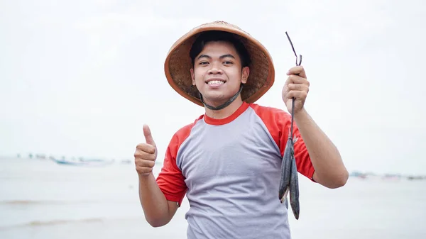 Happy Young Fisherman Beach Holding His Catch Fish Shows Front — Stock Photo, Image