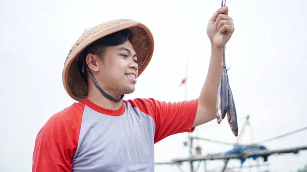 Happy Young Fisherman Beach Holding His Catch Fish Shows Front — Stock Photo, Image