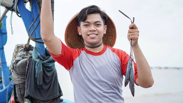Happy Young Fisherman Beach Holding His Catch Fish Shows Front — Stock Photo, Image
