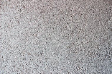 macun bıçağıyla düzensiz çizgiler ve darbelerle uygulanan doldurma macununun dokulu arka planı