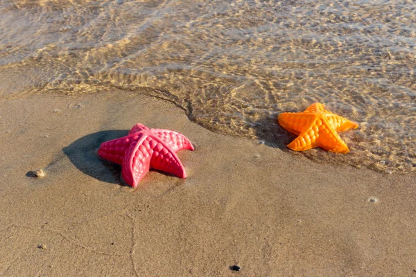 Summer Holiday, Beach Waves Starfish and colored toys — Stock Photo, Image