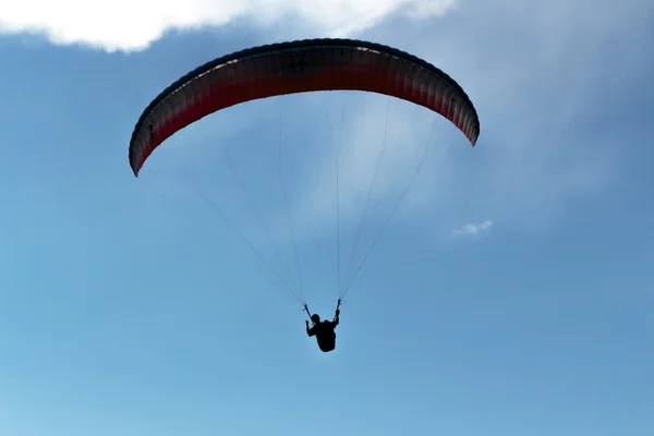 Blue sky, parachute and human silhouette. adventure — Stock Photo, Image