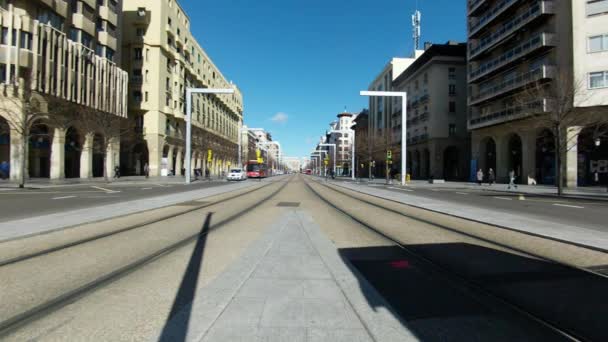 Tram goes away on a wide avenue in the city with a blue sky on a background — Stock Video