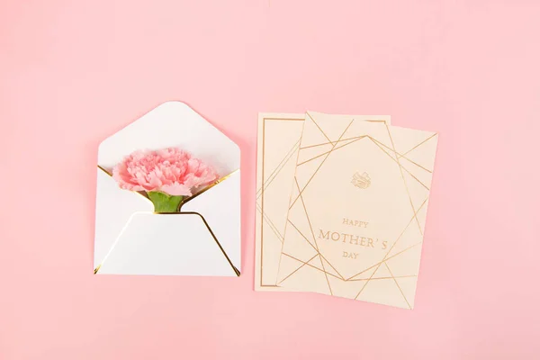 Pink carnations flower with card on pink background.Happy Mothers day