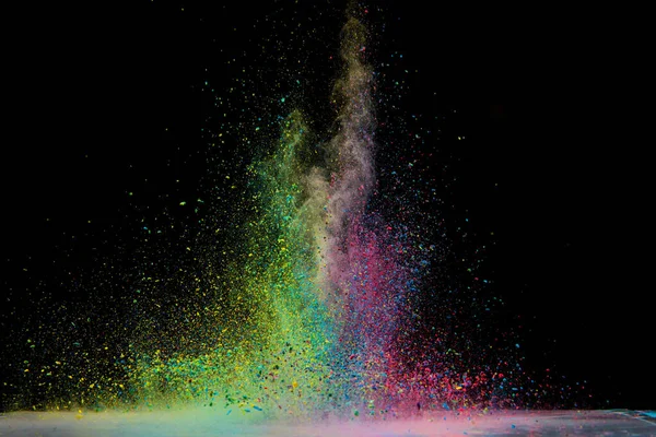 Explosion of colored powder isolated on black background. Abstract colored background