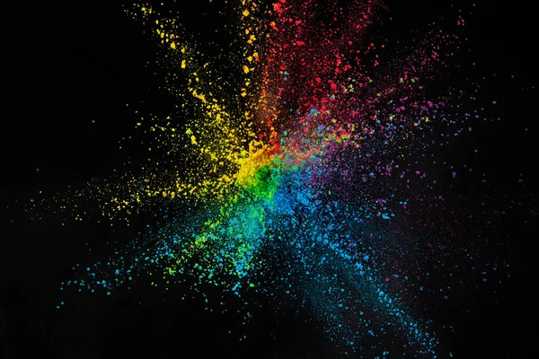 Explosion of colored powder isolated on black background. Abstract colored background