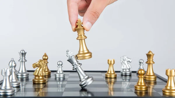 Plan leading strategy of successful business competition leader concept, Hand of player chess board game