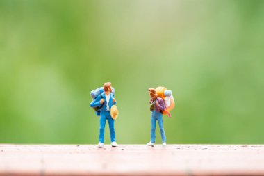 Minyatür insanlar: Seyahat eden sırt çantalı gezginler, seyahat macera konsepti olarak kullanılıyor.