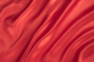 Soyut kırmızı ipek kumaş dokusu arkaplanı. Kumaş yumuşak dalga. Saten hazineleri.