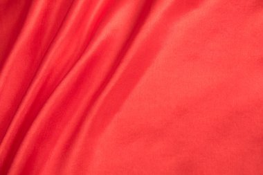 Soyut kırmızı ipek kumaş dokusu arkaplanı. Kumaş yumuşak dalga. Saten hazineleri.