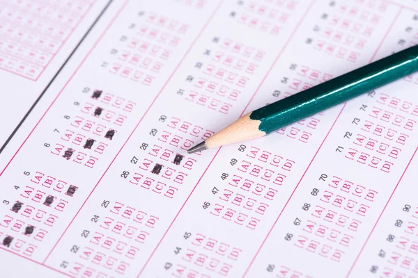 Pencil on answer sheets or Standardized test form with answers bubbled.